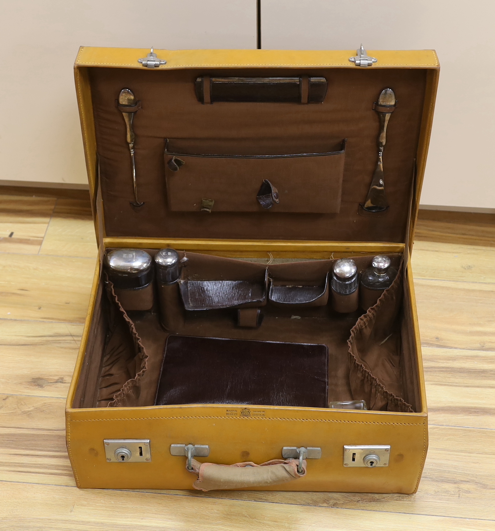 A vintage Mappin and Webb vanity case with five silver mounted bottles and shaving kit 51cm wide